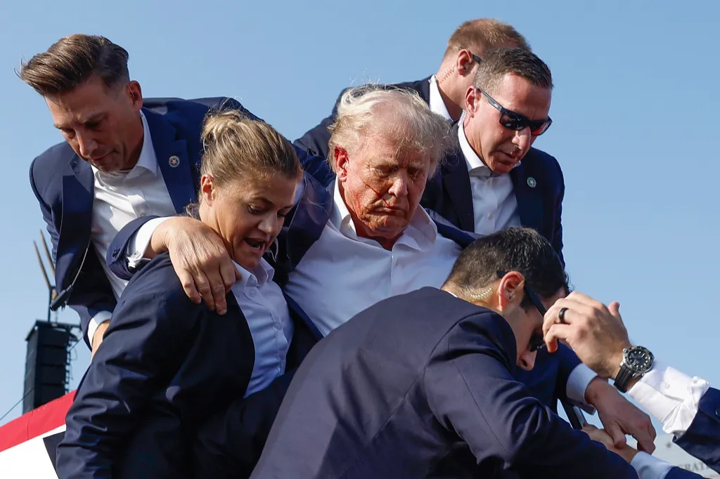 Donald Trump is rushed offstage by U.S. Secret Service agents after being grazed by a bullet during a rally.