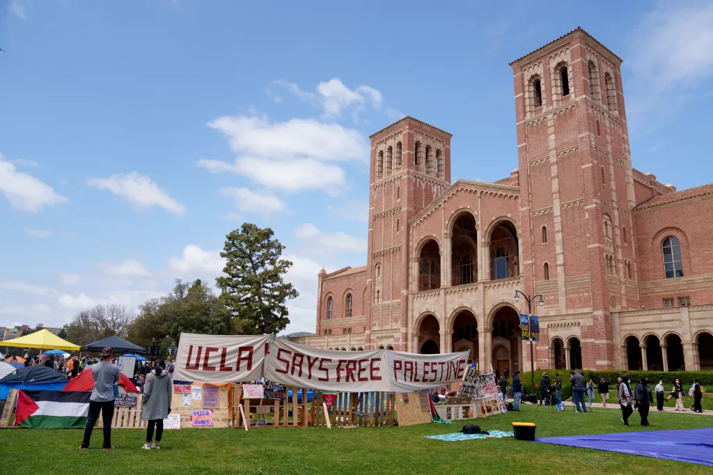 Pro-Palestinian demonstrators occupy an encampment on the campus of UCLA, featuring a large banner reading