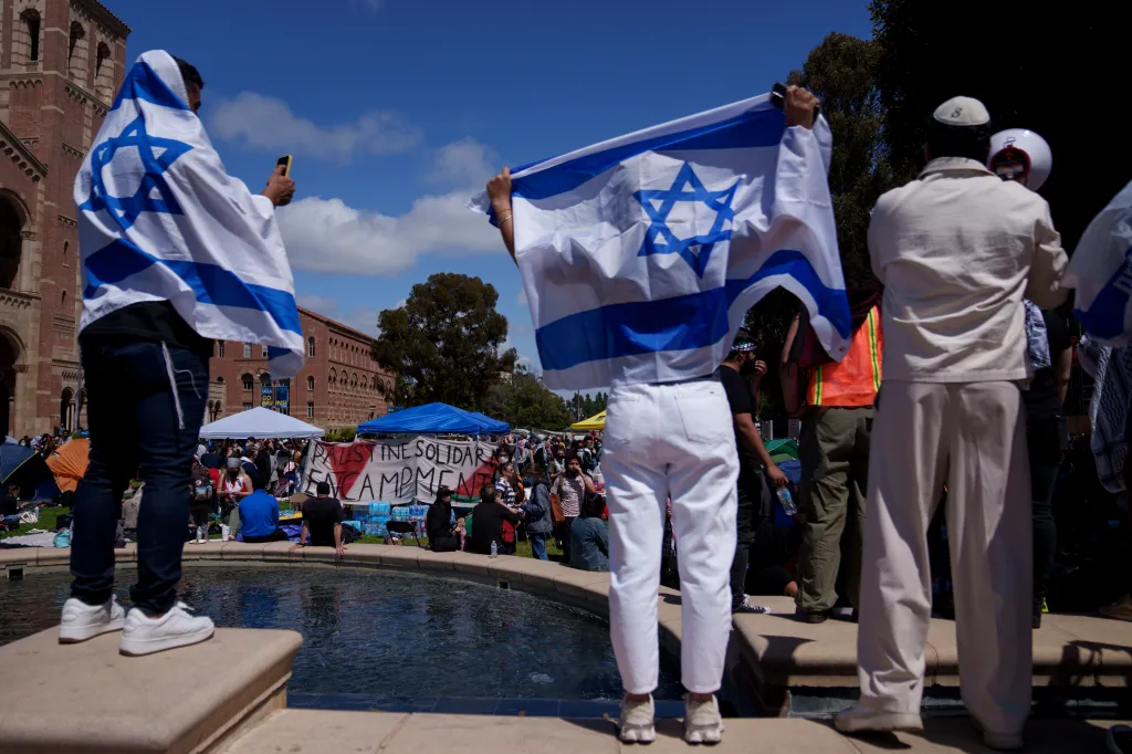 Pro-Israel demonstrators stand near a pro-Palestine encampment on the UCLA campus.