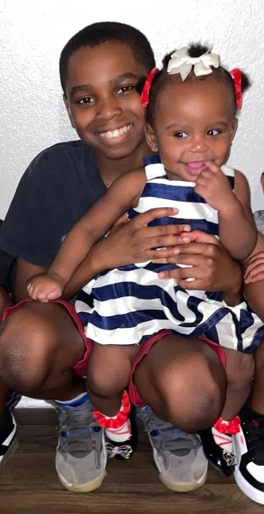 Sha'Michael Russell holding his younger sister.