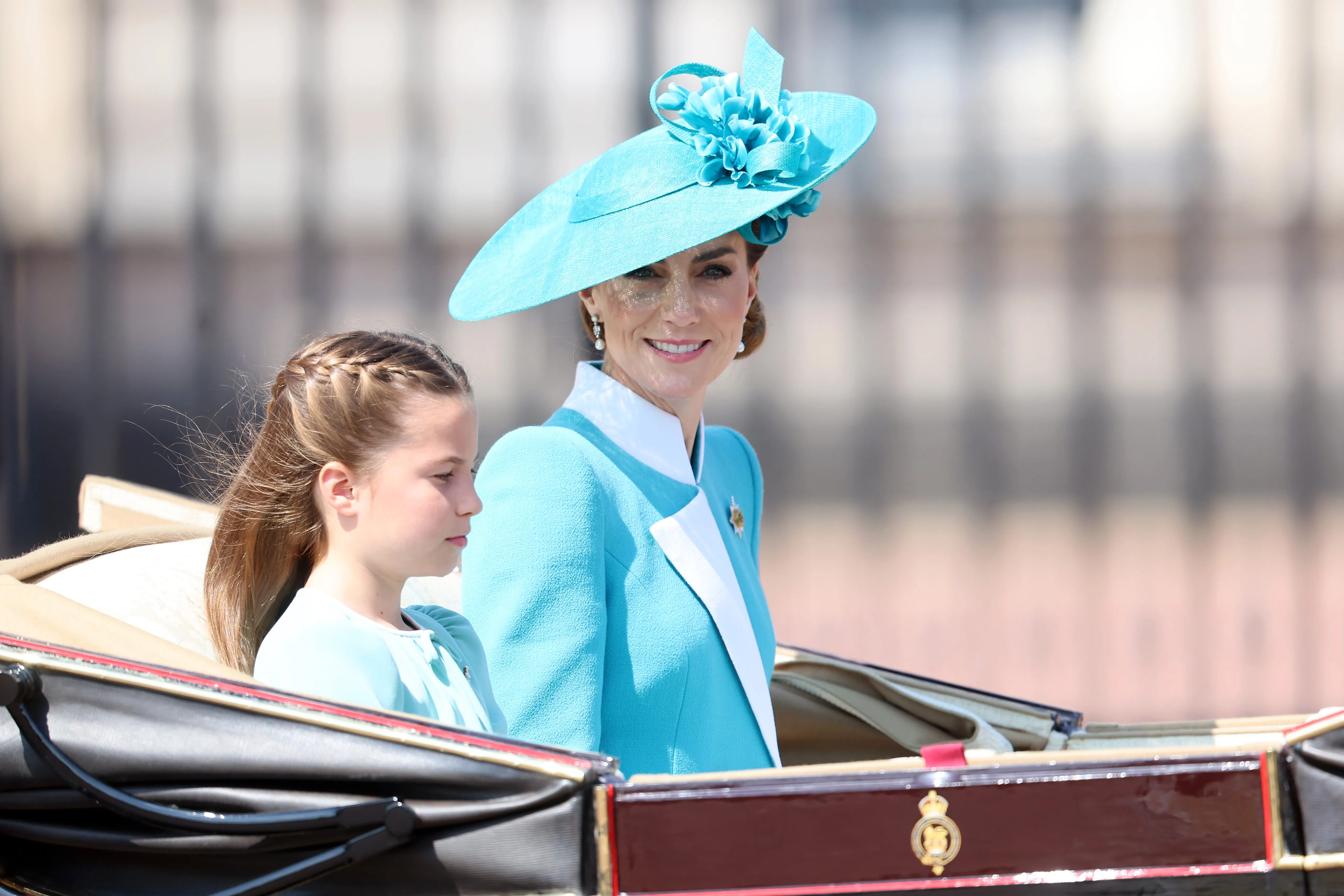 Princess Charlotte of Wales and Catherine, Princess of Wales ride in a carriage during Trooping The Colour.