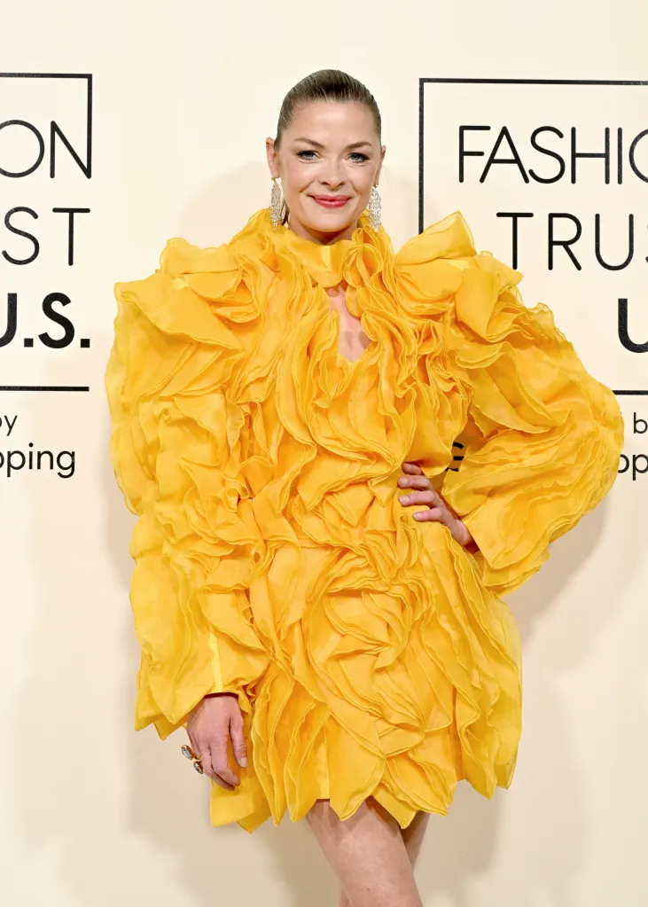 Jaime King attends the Fashion Trust U.S. Awards wearing a bright yellow ruffled dress.