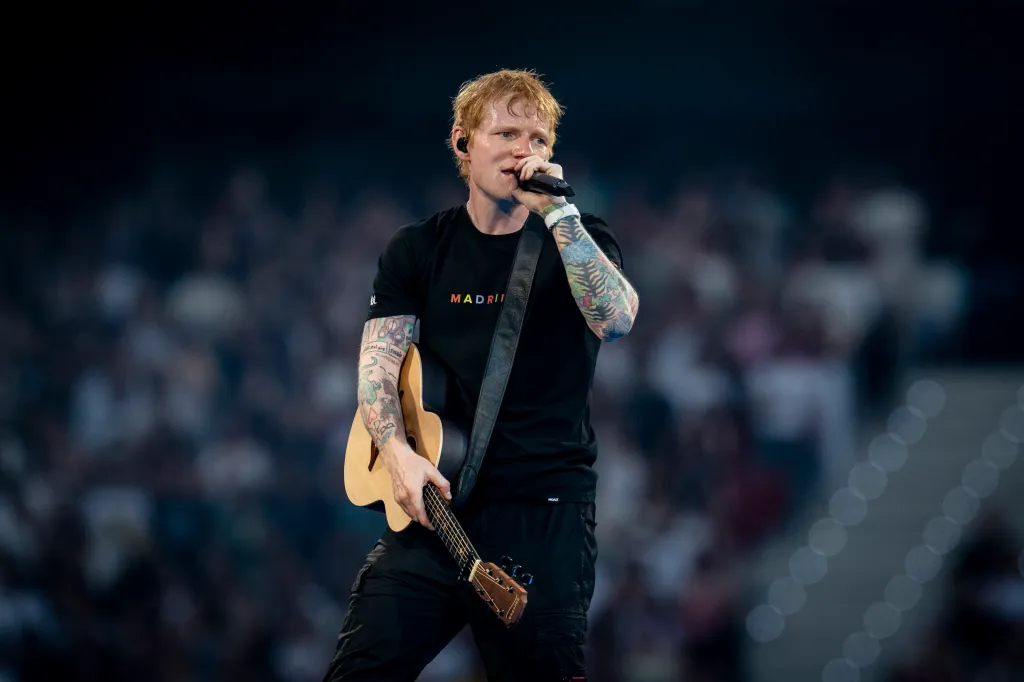 Singer Ed Sheeran performs on stage with a guitar during his concert in Madrid.