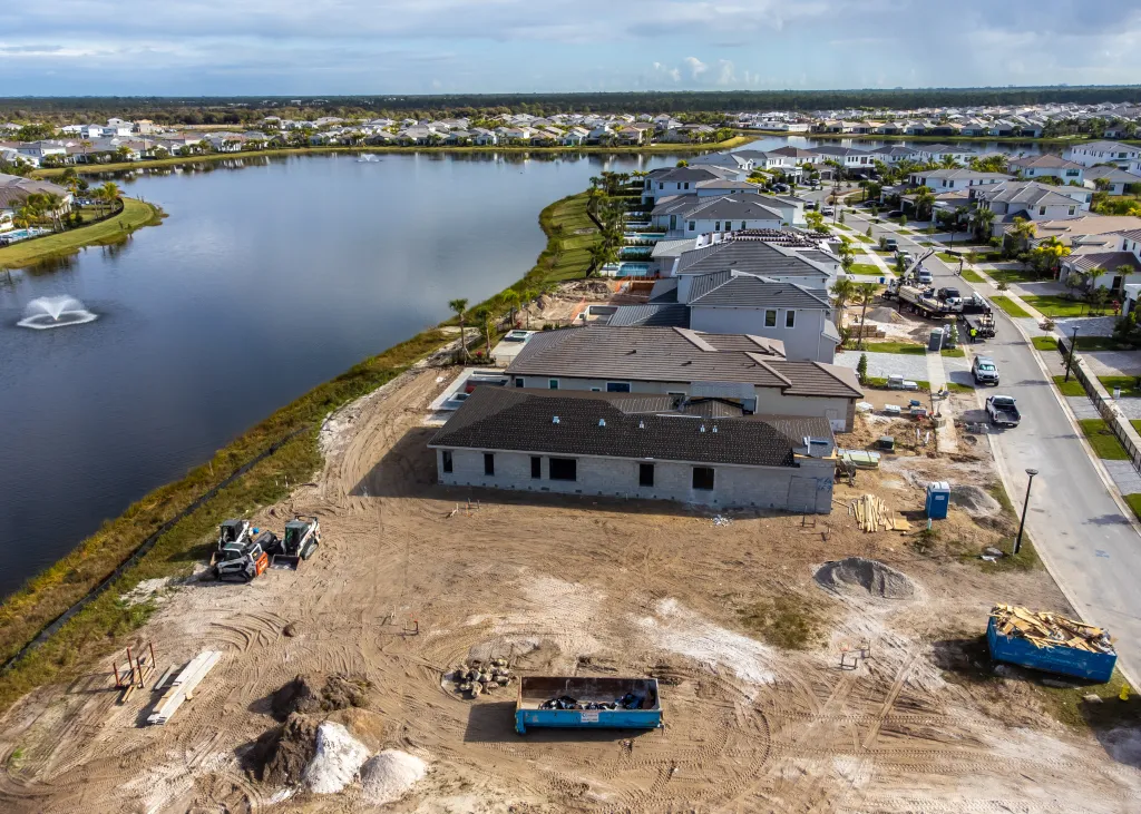 Aerial view of homes under construction near a body of water in Florida.