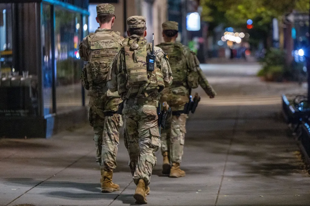 National Guard members patrol a street at night in Washington, D.C.