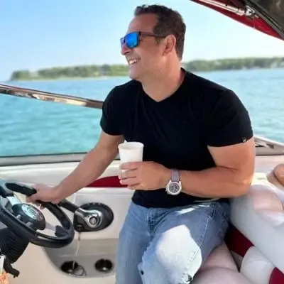 Peter Mangiameli driving a boat.