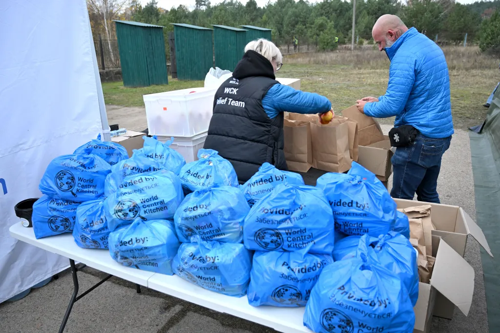 Volunteers pack food parcels and supplies into bags for a humanitarian mission in Ukraine.