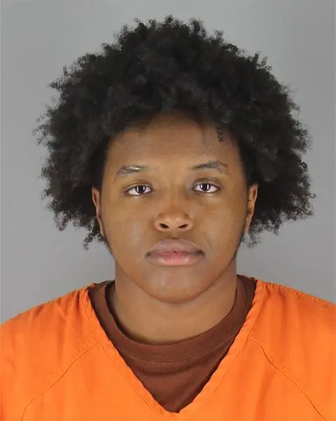 Booking photo of Adam Abdihakeem Adam in an orange jail uniform.
