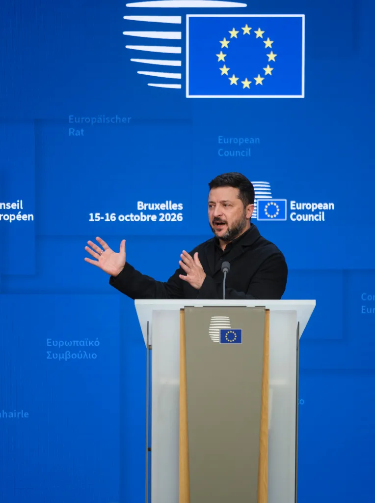 Ukrainian President Volodymyr Zelenskyy speaks at a podium during an EU Summit at the European Council in Brussels.