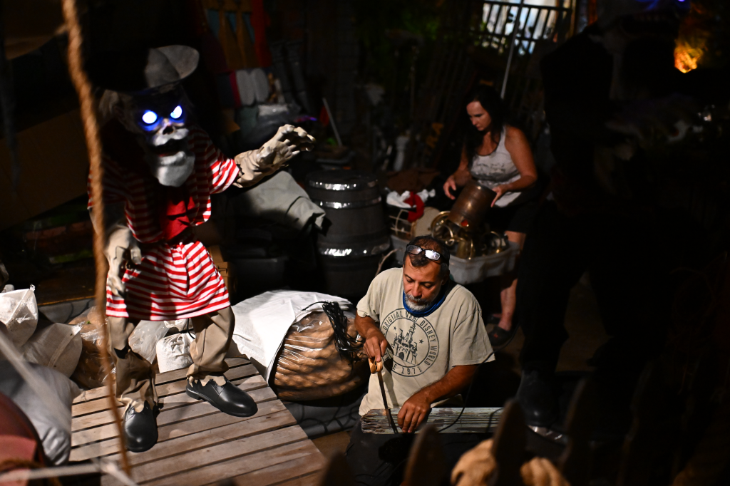 Arnulfo Padilla and Tina Schaefer work on Pirates of the Caribbean-themed Halloween decorations.