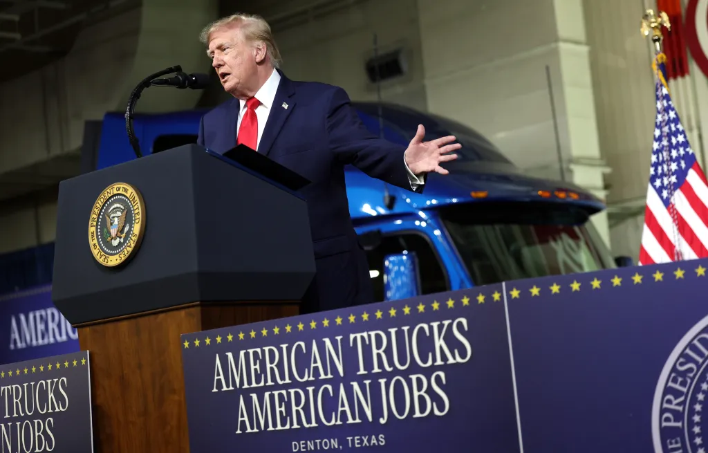 U.S. President Donald Trump speaks at a podium during a visit to the Peterbilt Motors truck plant in Denton, Texas.