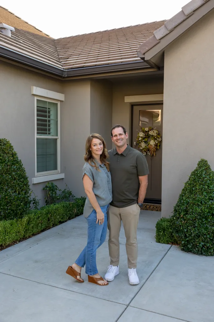 Justin and Lynne Derby stand outside their rented home in Fresno, California.