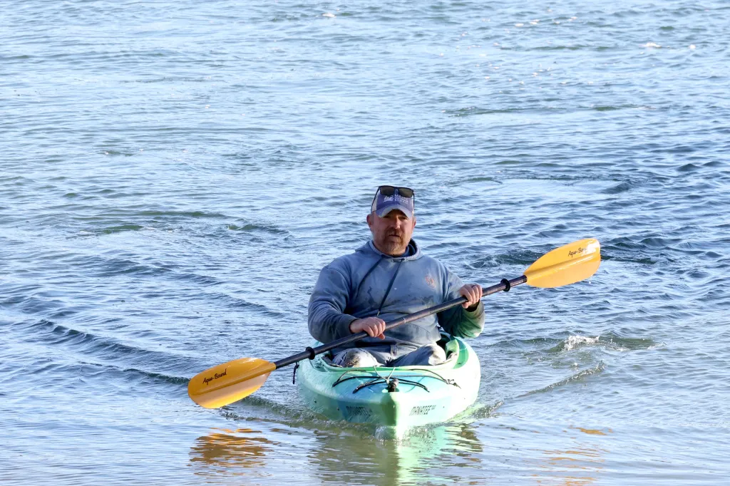 Graham Platner paddles a canoe in Sullivan, Maine.