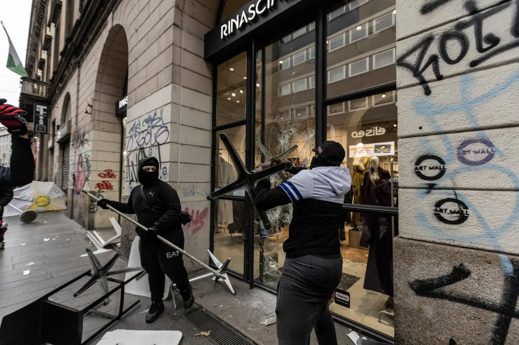 Protesters vandalize a shop in Milan, Italy.