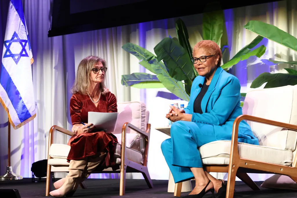 Los Angeles Mayor Karen Bass and City Councilmember Nithya Raman seated on a stage during a panel discussion.