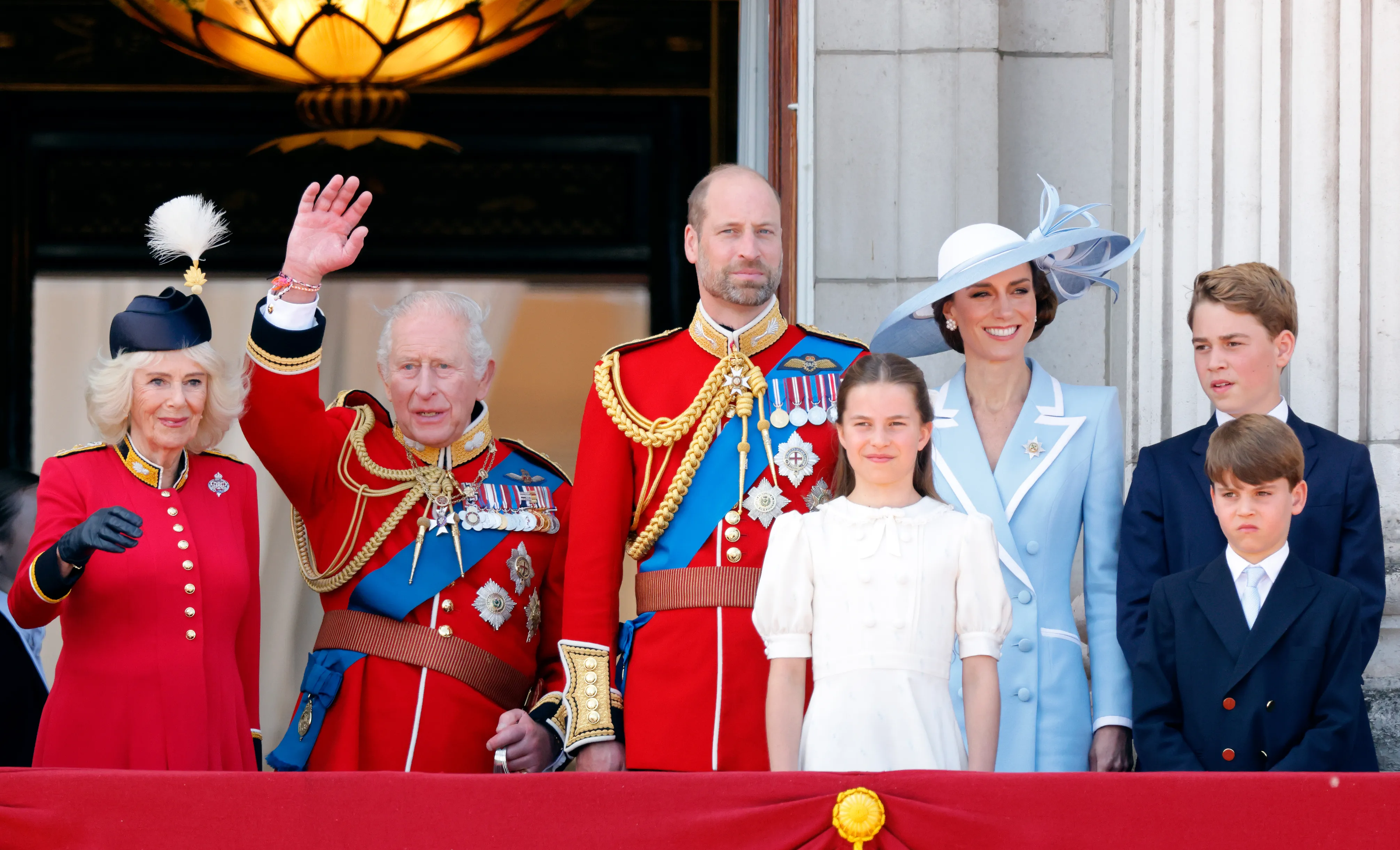 Queen Camilla, King Charles III, Prince William, Catherine, Princess of Wales, and their children Princess Charlotte, Prince George, and Prince Louis on the balcony of Buckingham Palace.