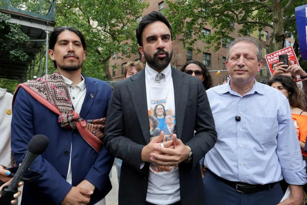 Candidate Illapa Sairitupac, New York City Mayor Zohran Mamdani, and former New York City Comptroller Brad Lander stand together outdoors during a primary election campaign event.