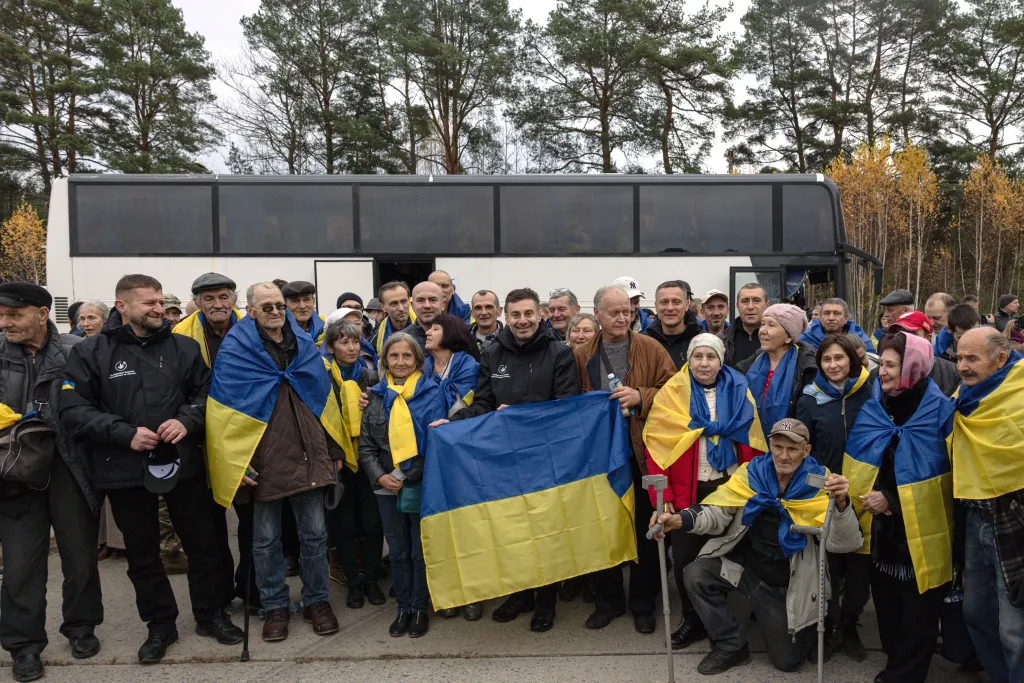 Dmytro Lubinets poses for a group photo with evacuees from Oleshky, Ukraine.