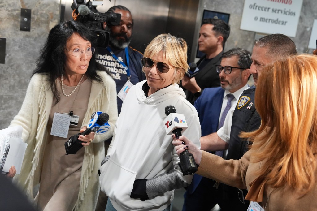 Selma Blair surrounded by reporters and photographers after leaving court in New York.