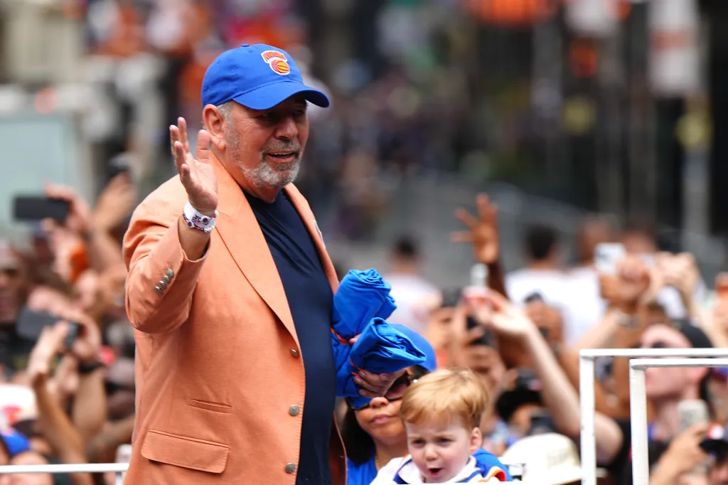 New York Knicks owner James Dolan waves to a crowd during the team's championship parade.