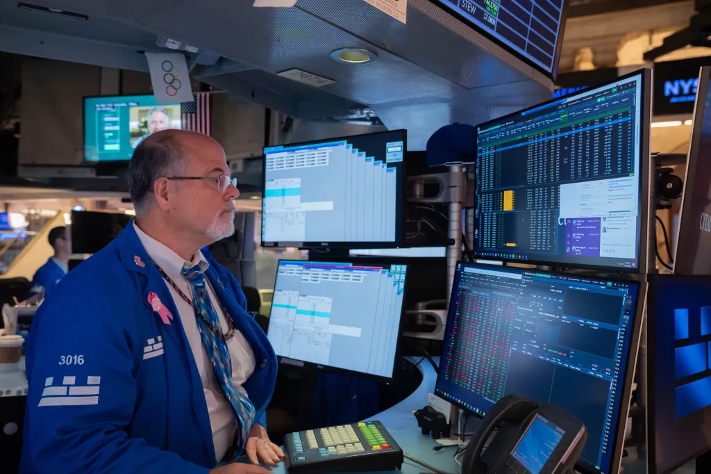 A trader working at a computer terminal on the floor of the New York Stock Exchange.