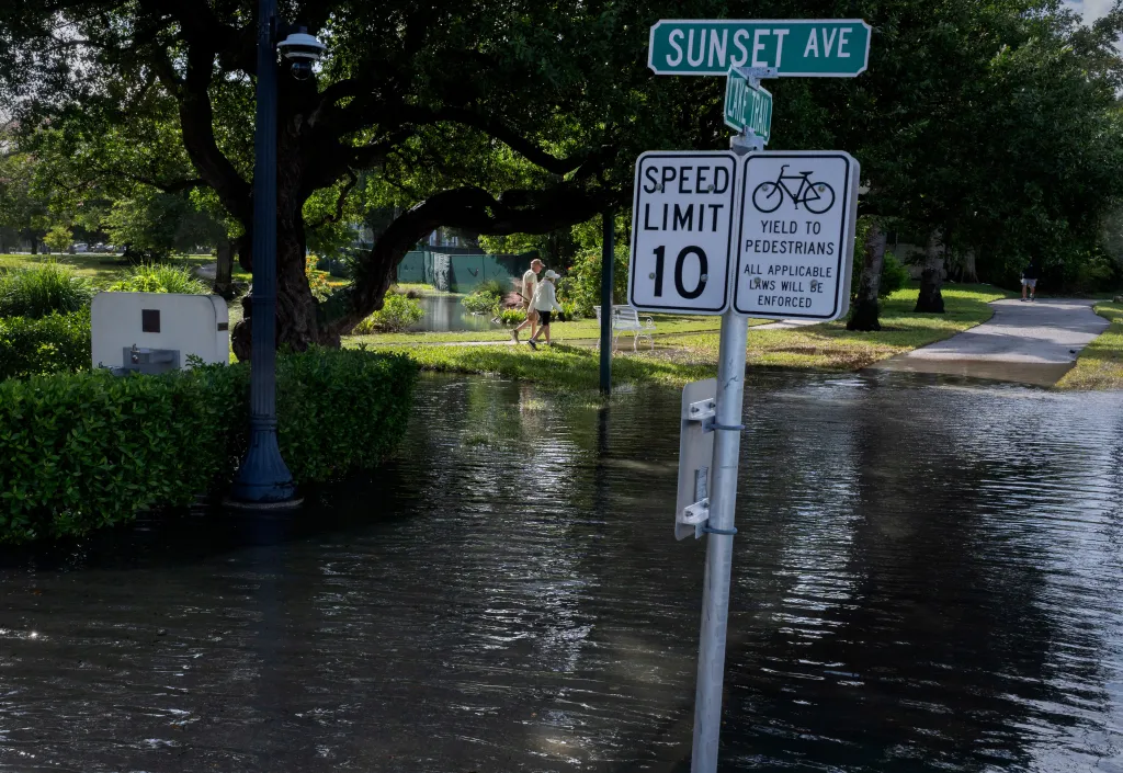 Severe coastal flooding inundates The Lake Trail in Palm Beach, Florida, submerging paths and surrounding areas.