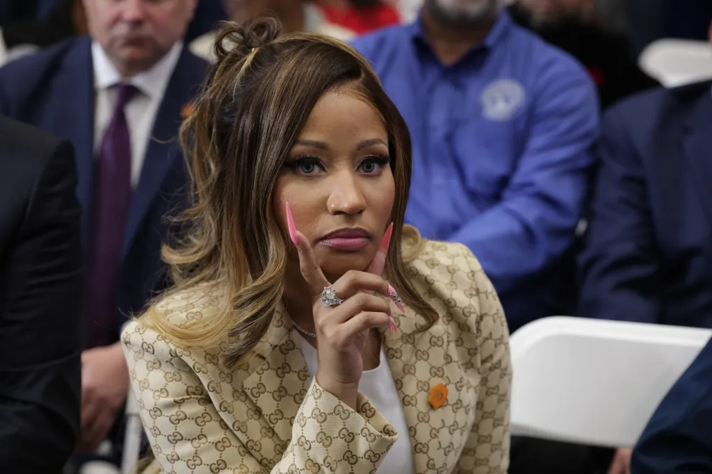 Singer Nikki Minaj listens as President Donald Trump speaks during a campaign rally in Port Huron, Michigan on Oct. 25, 2026.