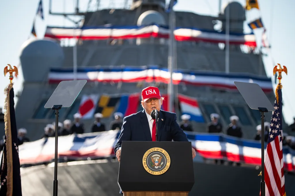 President Donald Trump speaks at a podium in front of a ship at Tradepoint Atlantic in Sparrows Point, Maryland.