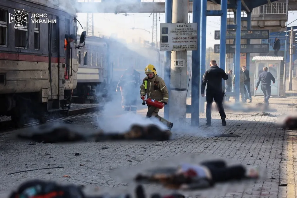 Emergency personnel work at a railway station following a drone strike.