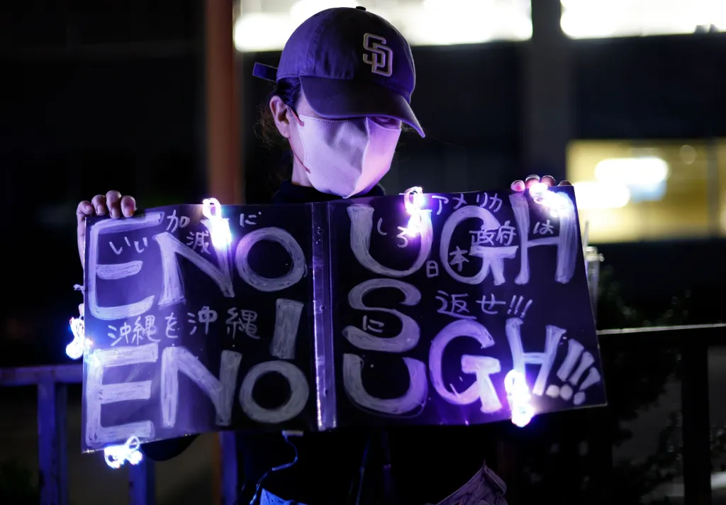 A young woman holds a placard during a rally in front of the Prime Minister's Office in Tokyo, Japan, on Monday.