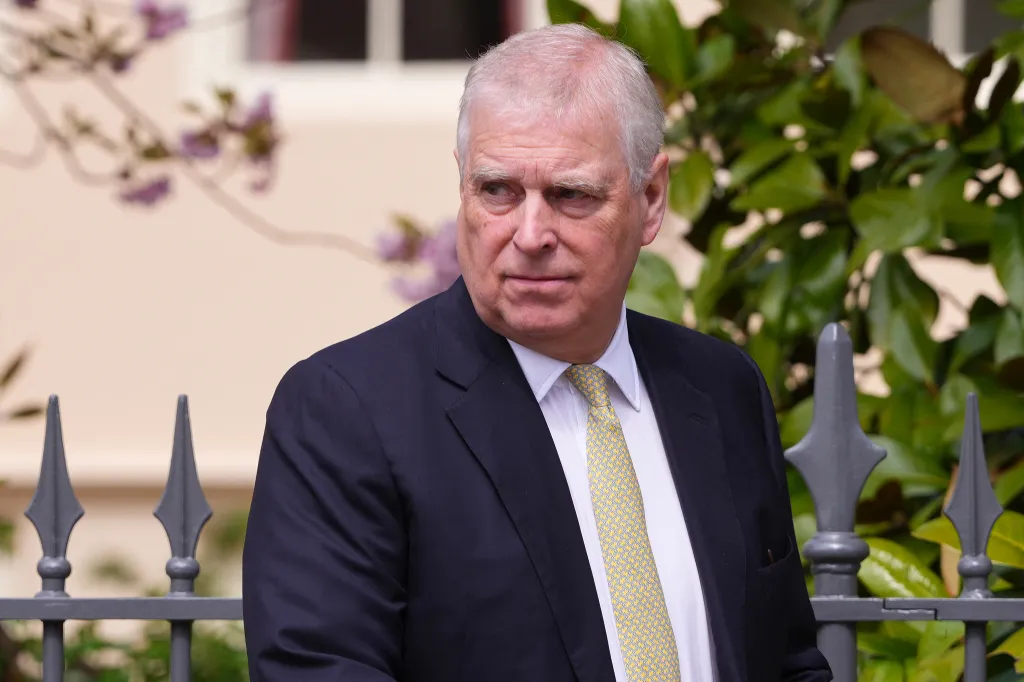 Prince Andrew, Duke of York, wearing a suit and yellow tie.