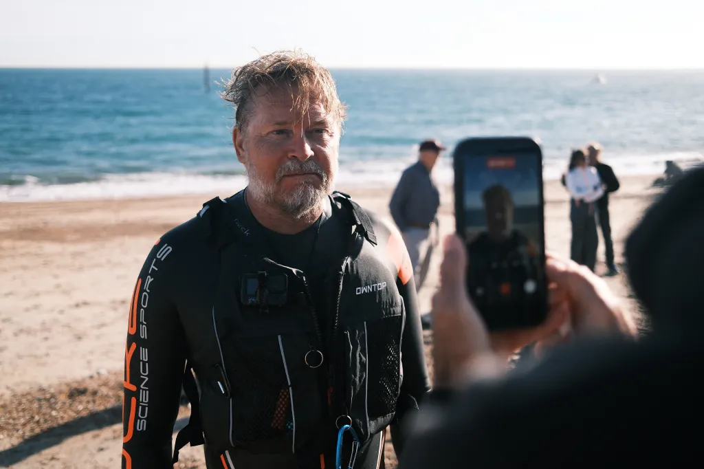 British adventurer Karl Bushby in a wetsuit on a beach near Dover after swimming the Channel from France.