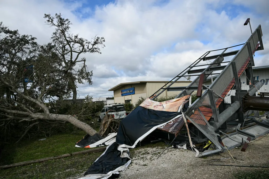 A downed tree and damaged storefront signage in Gulf Breeze, Florida, following Hurricane Isaias.