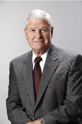 Portrait of Steve Maguin in a suit and tie.