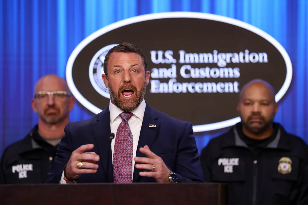 Homeland Security Secretary Markwayne Mullin speaks at a press conference at ICE headquarters, flanked by ICE officials.