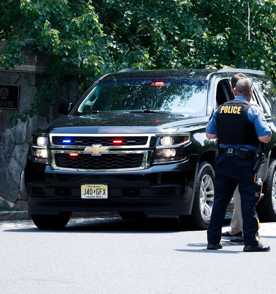 Secret Service agents stand guard by a black SUV outside Donald Trump's home in Bedminster, New Jersey.