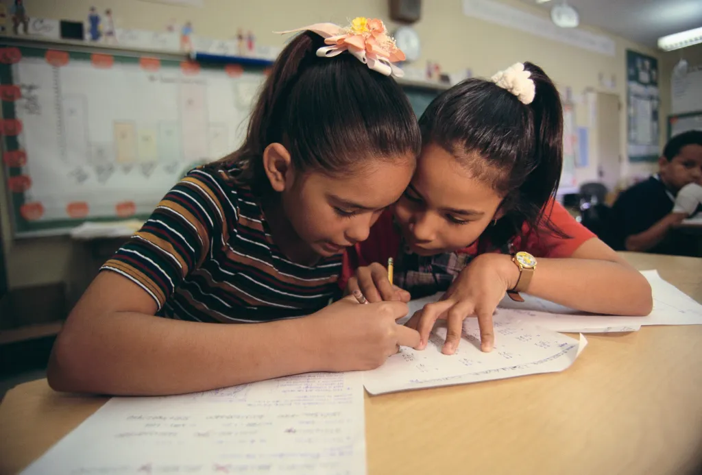 Two girls work together on an assignment at Evergreen Elementary School in East Los Angeles, California.