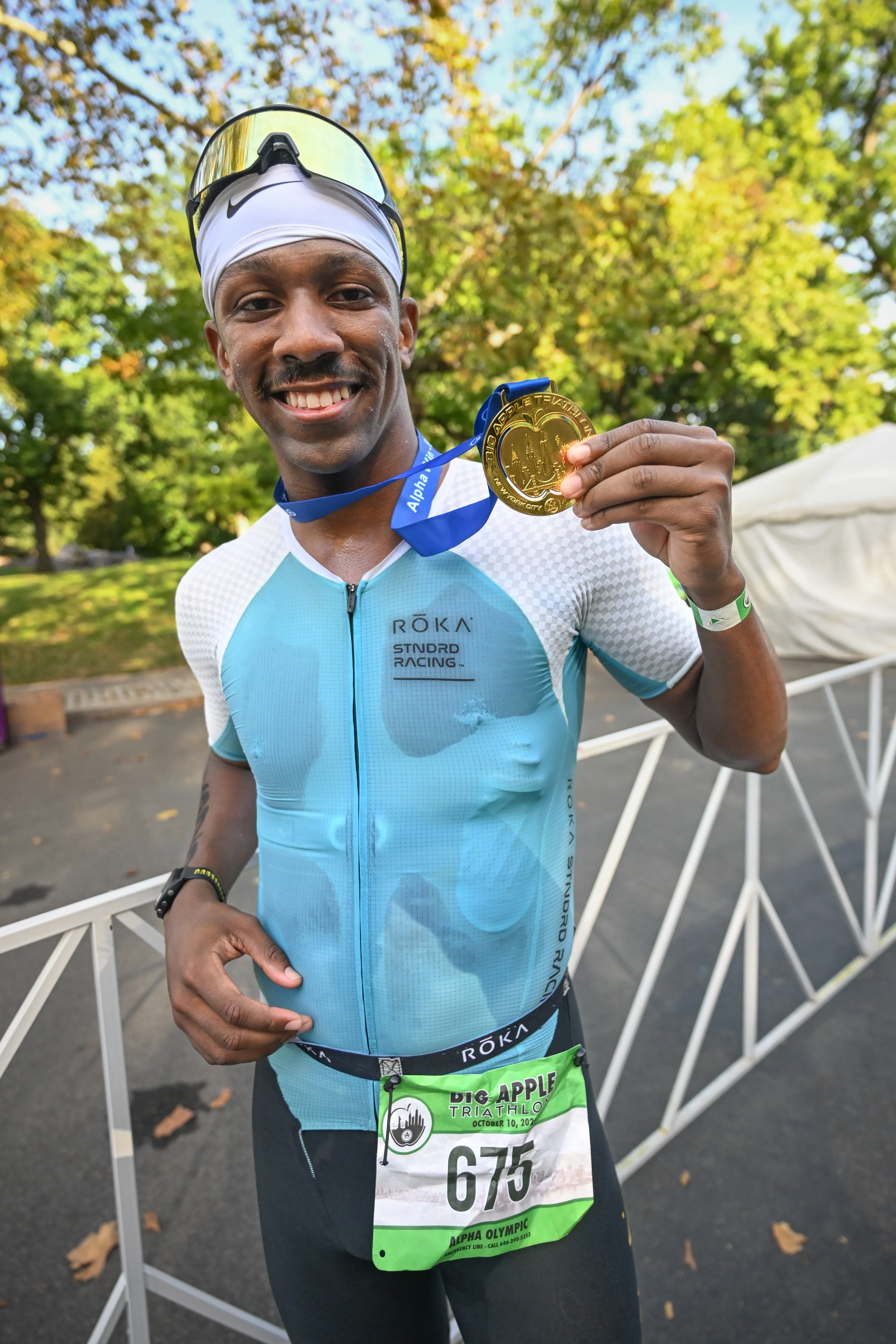 Andrew Gray, winner of the Big Apple Triathlon, poses with his medal.