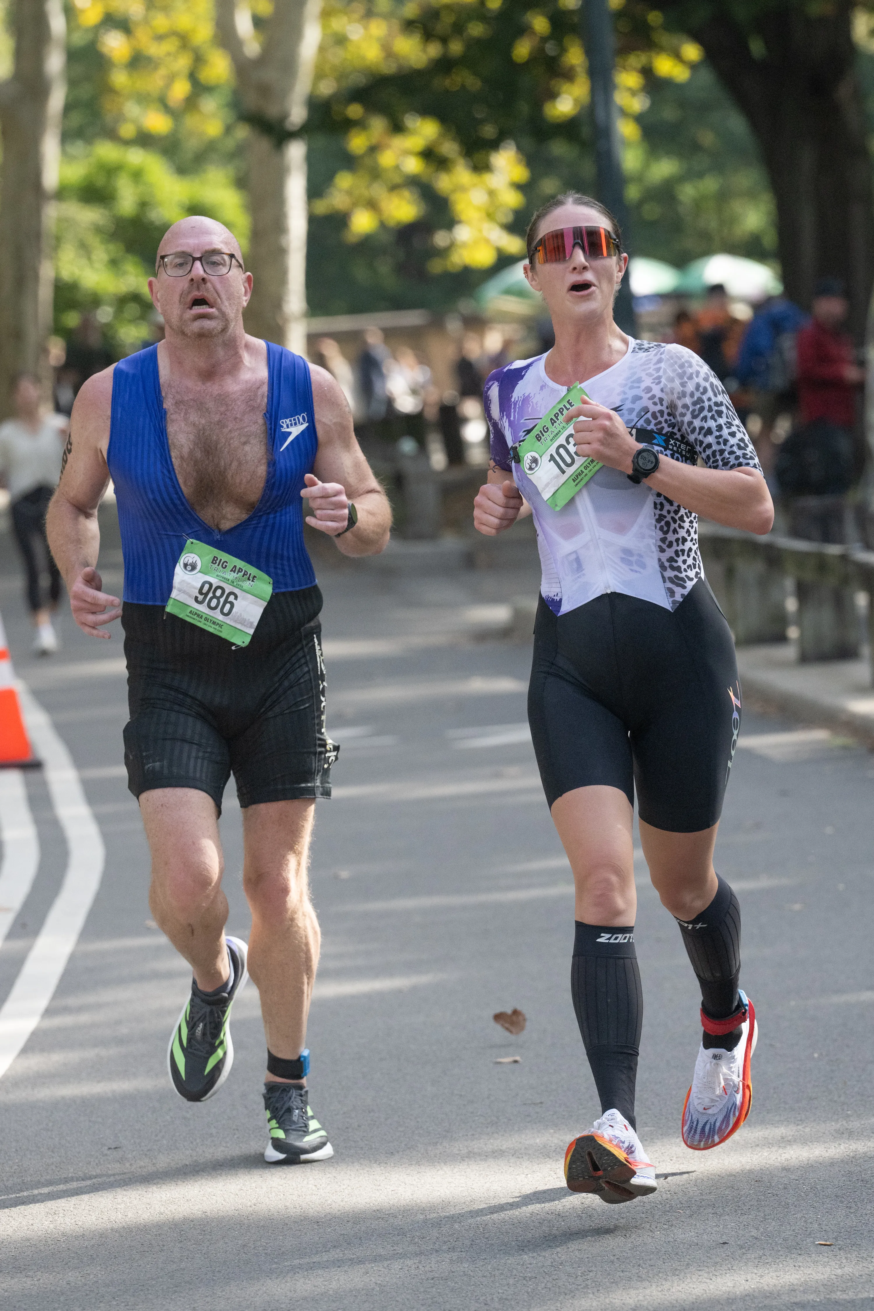 Two athletes run towards the finish line during the Big Apple Triathlon in Central Park.
