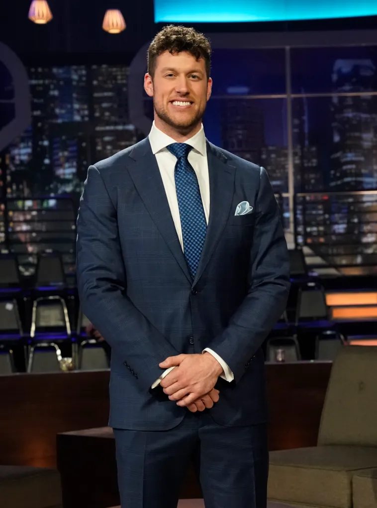 Clayton Echard in a blue suit on the set of The Bachelor.