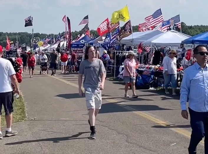 Thomas Matthew Crooks walks through a crowd at a Donald Trump rally.