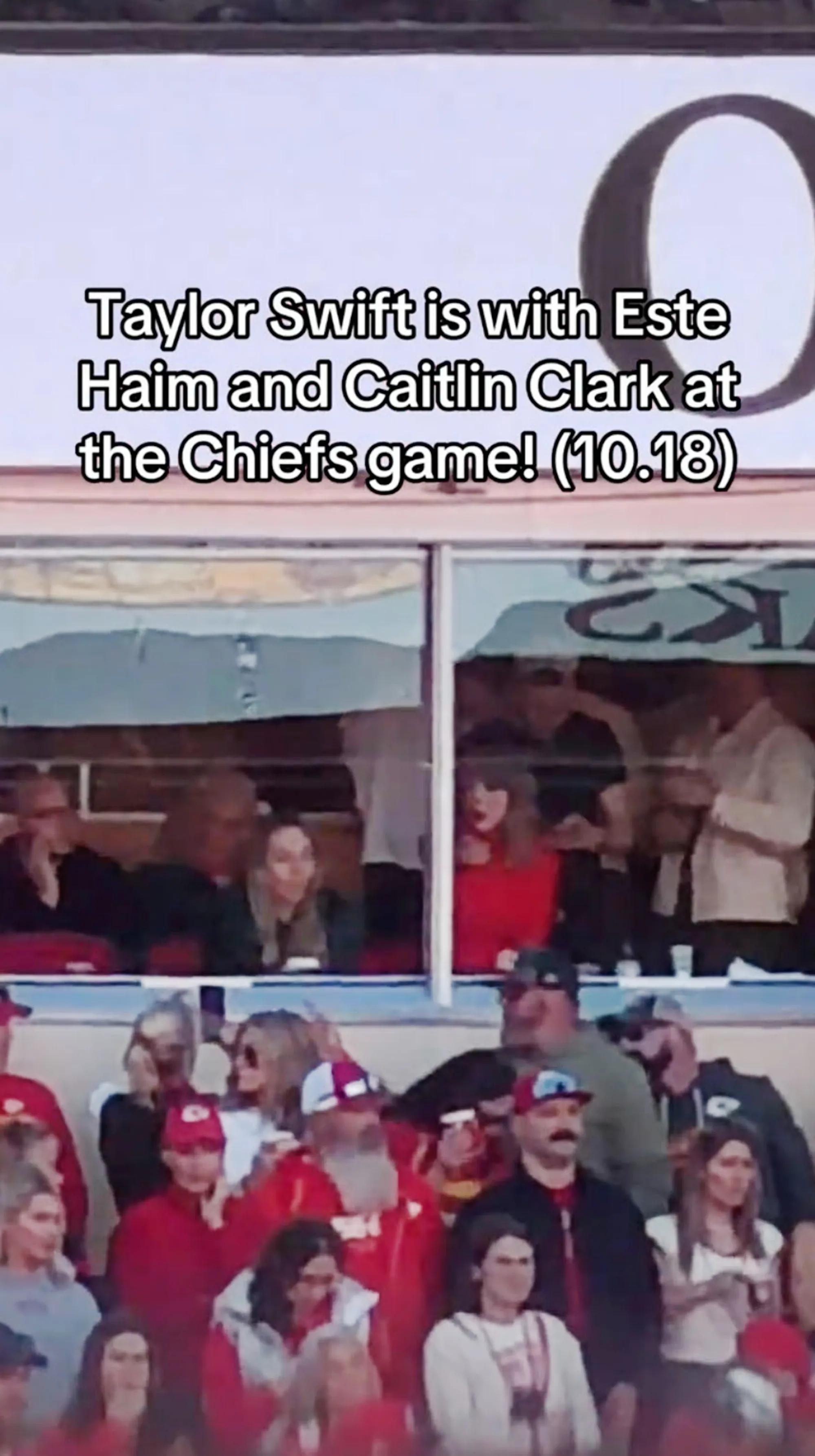 Taylor Swift sitting in a stadium suite.