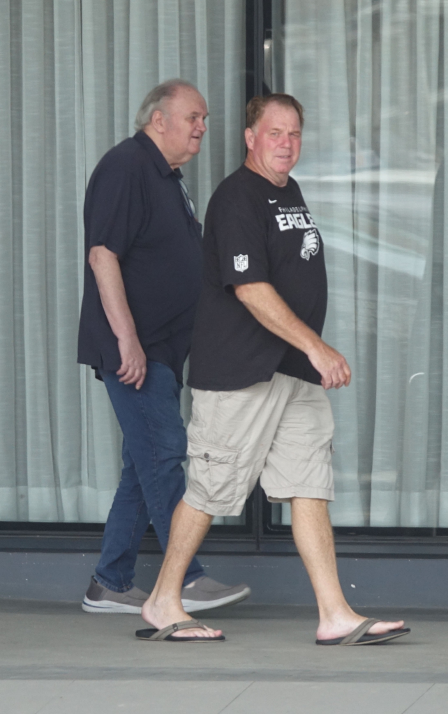 Thomas Markle and his son, Tom Markle Junior, walking together outside.