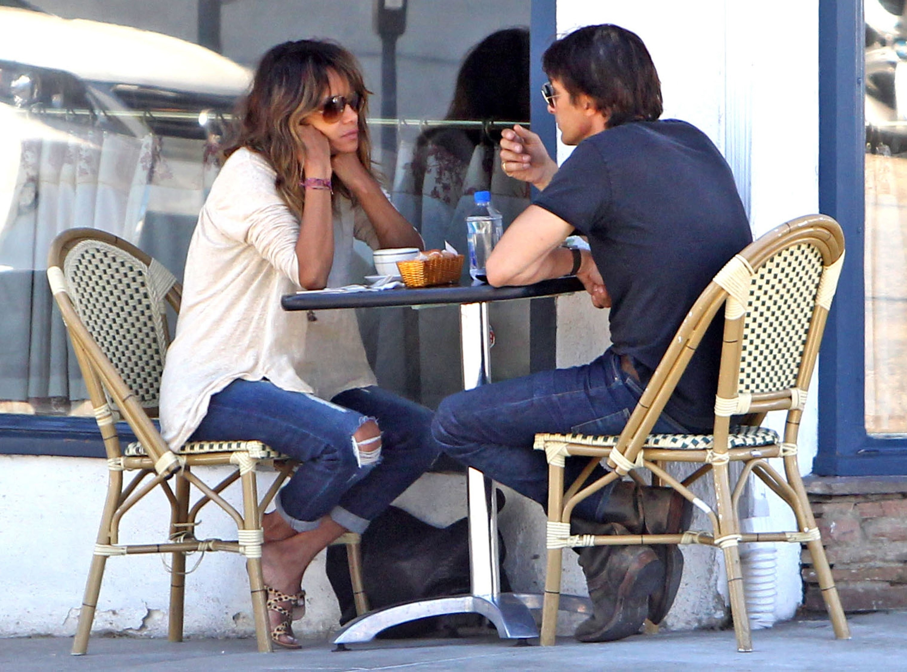 Halle Berry and Olivier Martinez sitting together at an outdoor table for breakfast.
