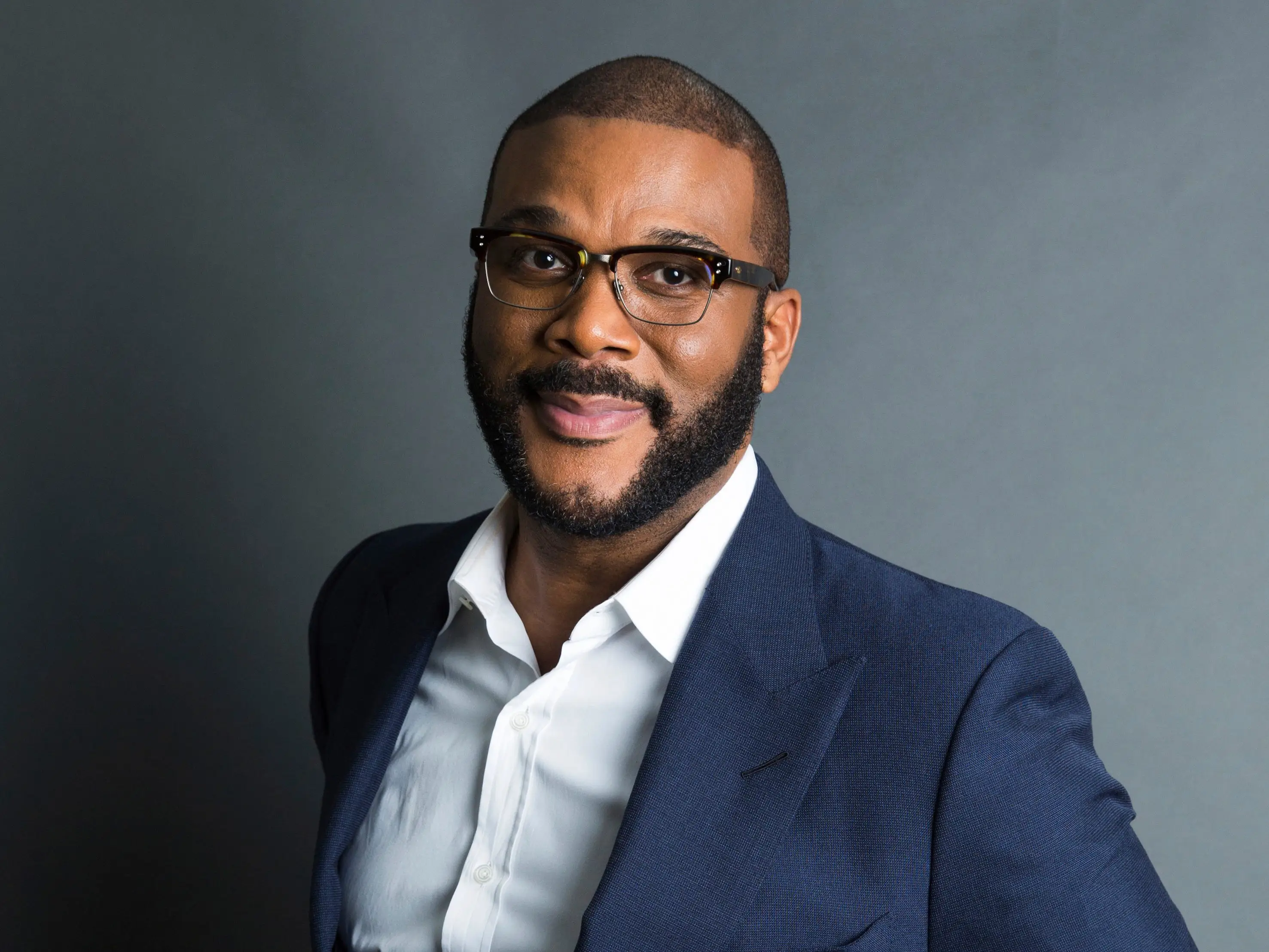FILE - In this Nov. 16, 2017, file photo, actor-filmmaker and author Tyler Perry poses for a portrait in New York. Perry is looking to reopen his 330-acre Atlanta-based mega studio soon, but other studios in Georgia are anxiously waiting for Hollywood's green light to return back to work. Perry plans on restarting production at the Tyler Perry Studios complex in July, making it one of the first studios to domestically reopen after production was halted a few months ago to combat the spread of the coronavirus. (Photo by Amy Sussman/Invision/AP, File)