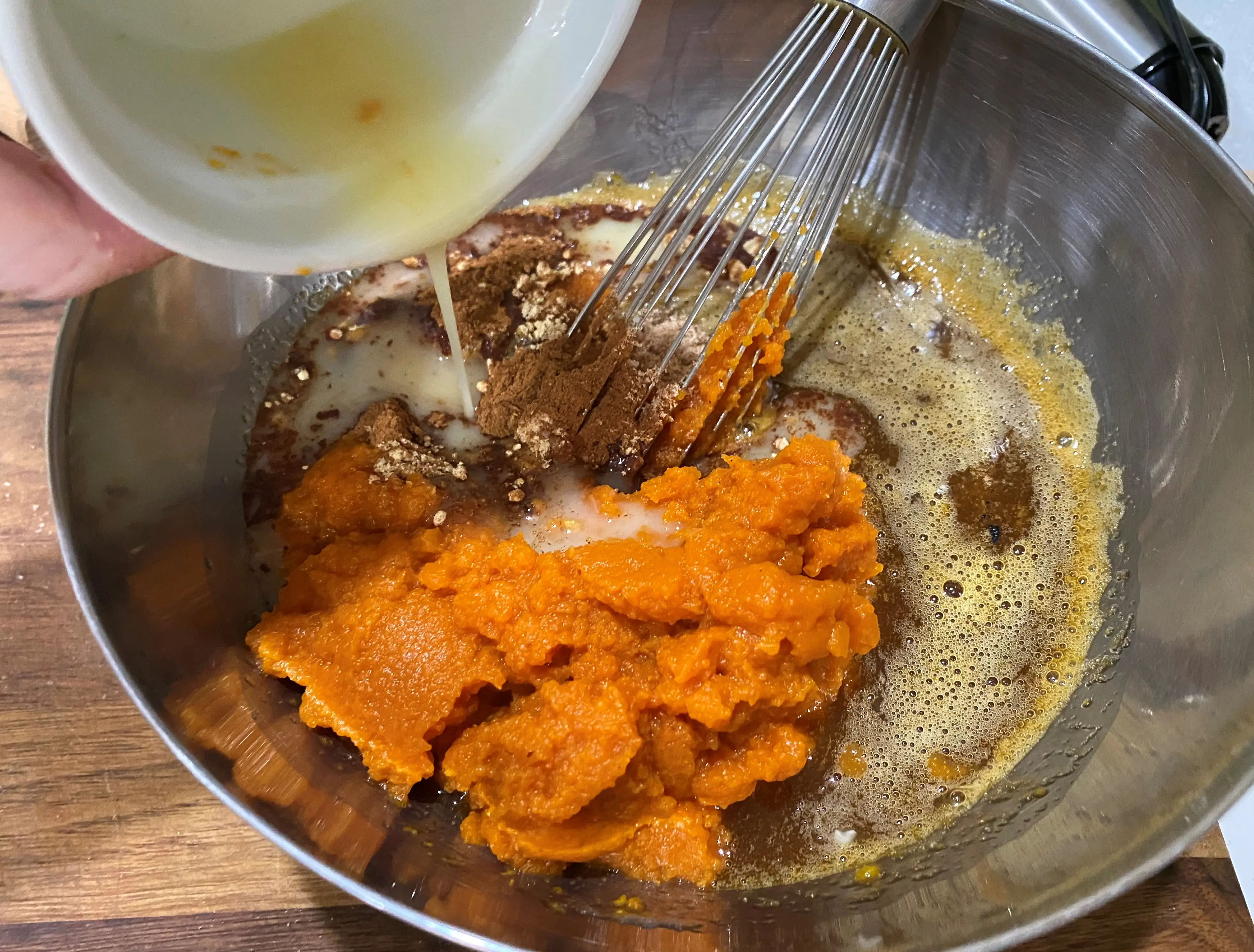 Mixing pumpkin, sugar, butter for bobby flay pumpkin pie