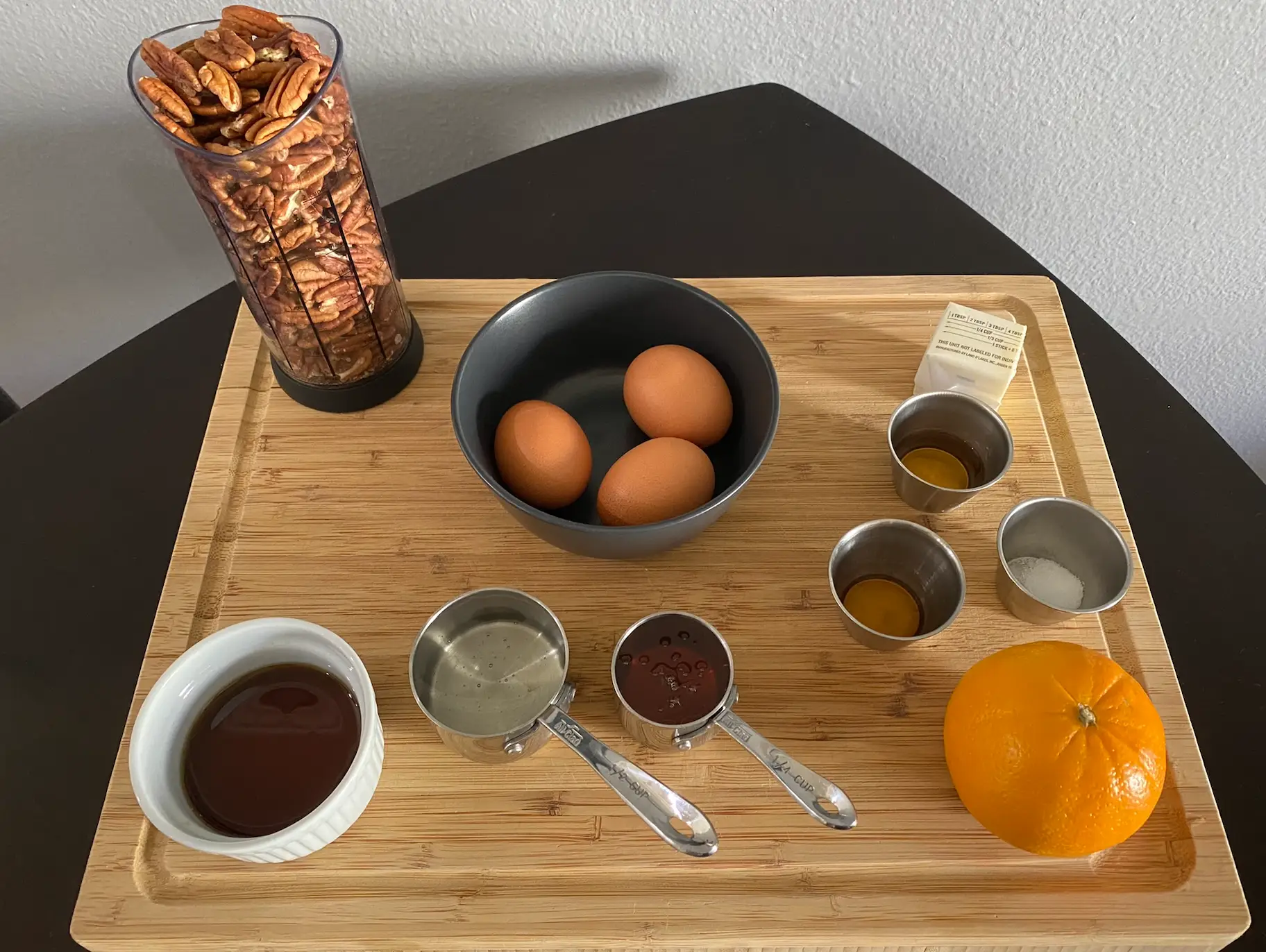 ingredients for ina garten's maple pecan pie on a cutting board