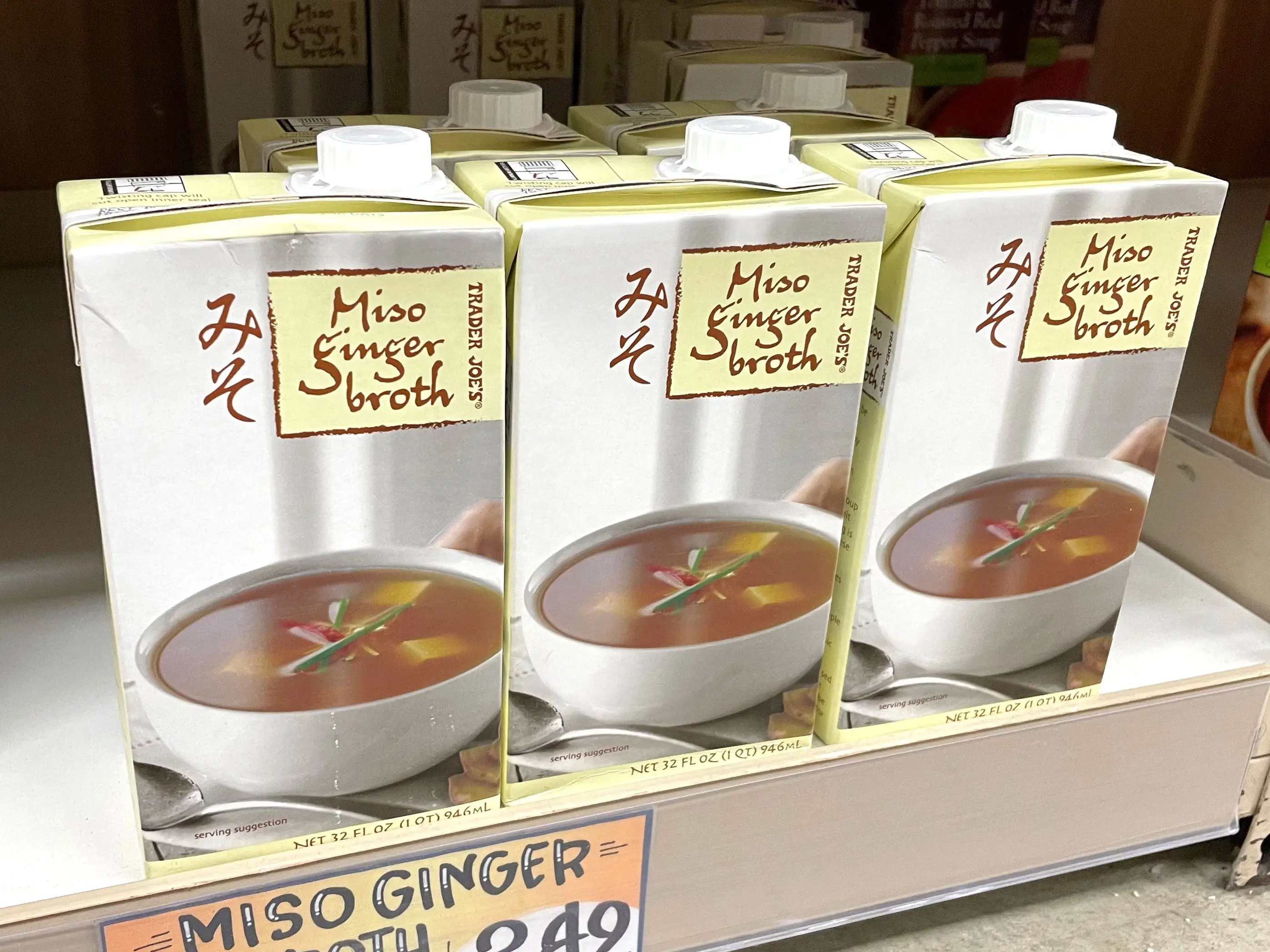 Containers of Trader Joe's miso-ginger broth on a shelf.