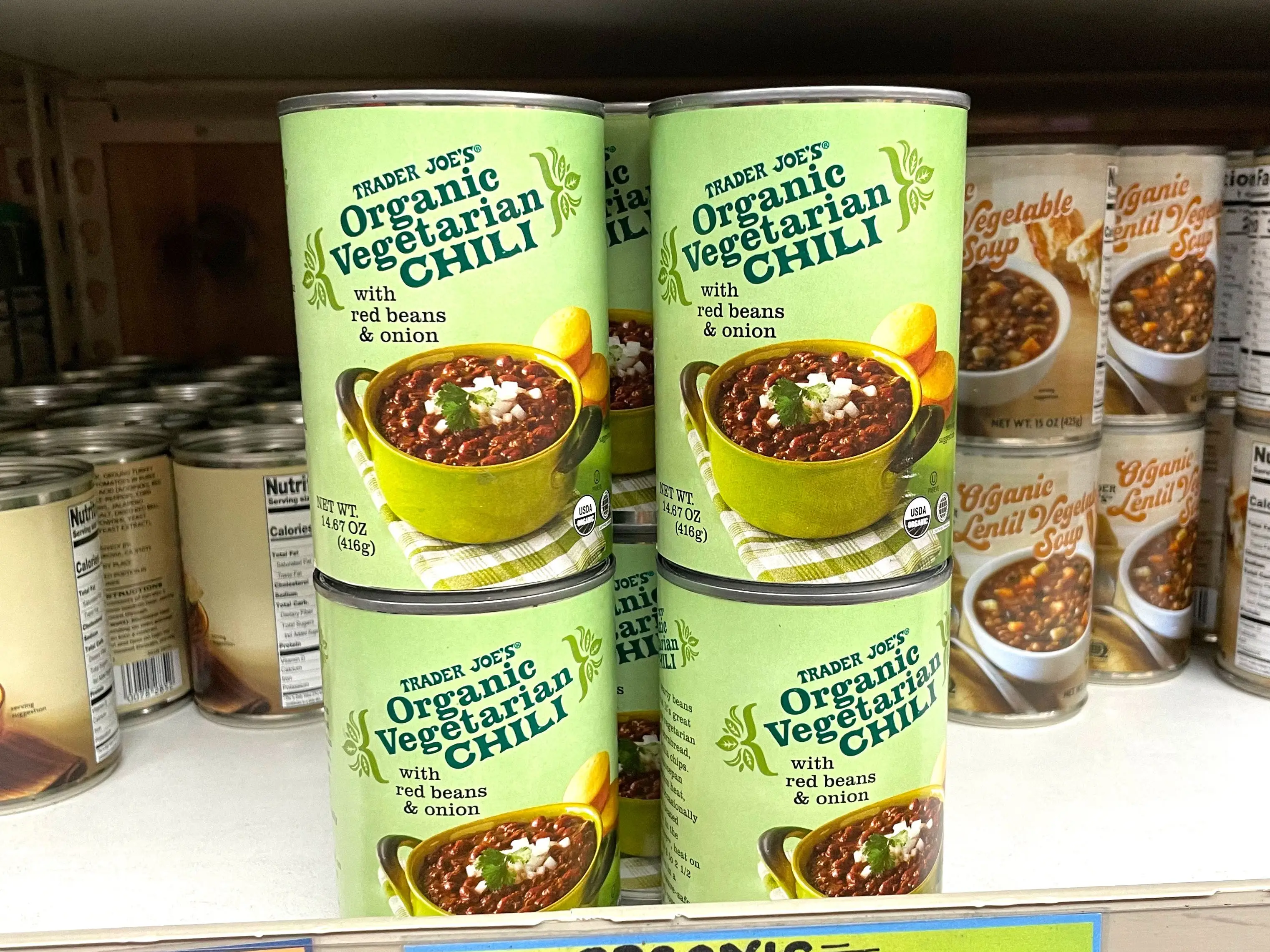Stacked cans of Trader Joe's organic vegetarian chili.