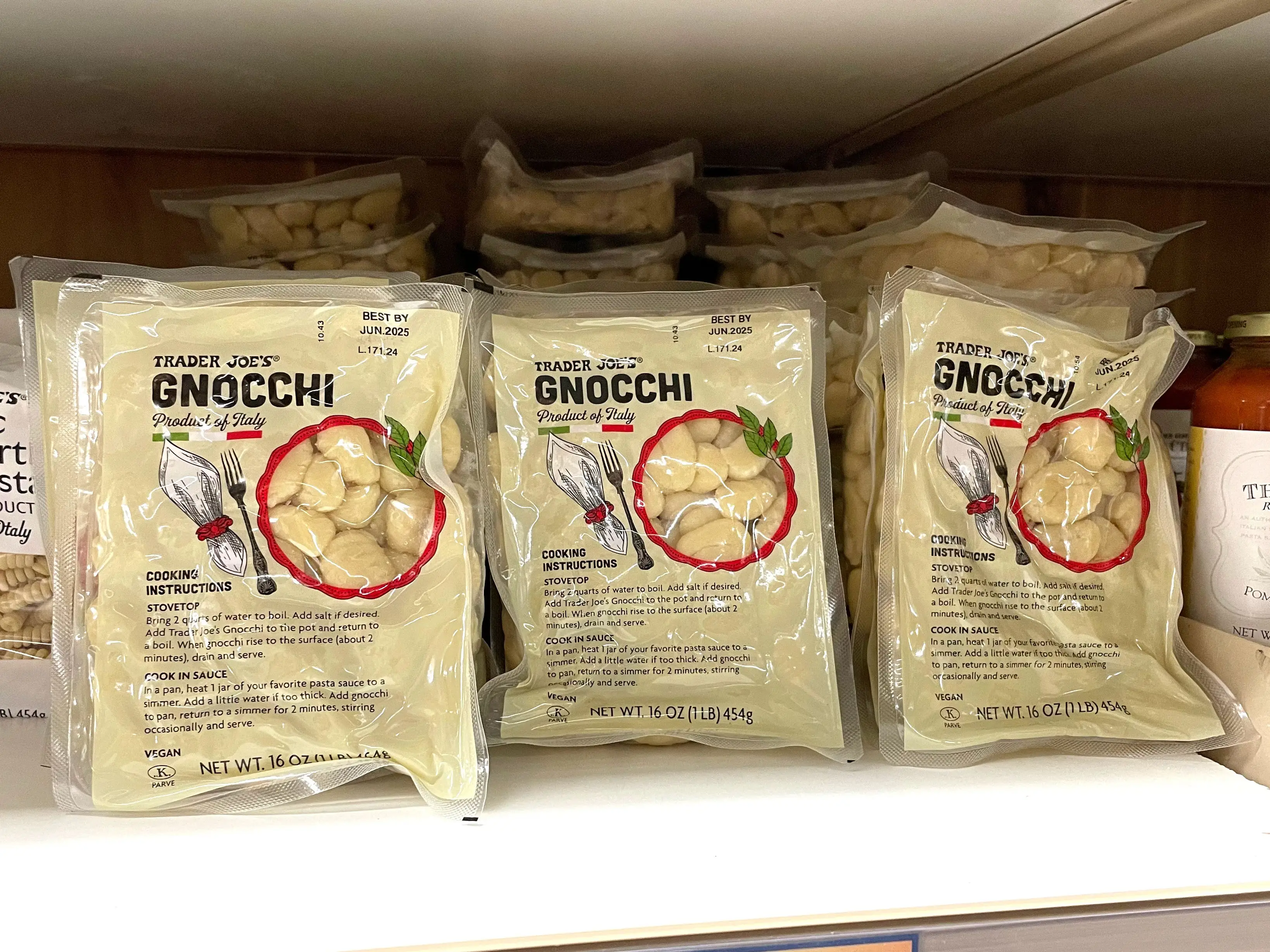 Containers of Trader Joe's gnocchi on a shelf.